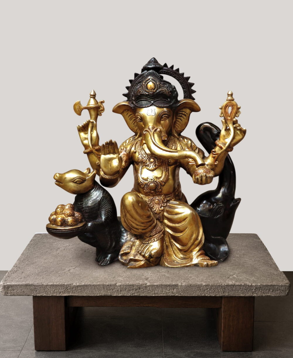 Golden ganesha sitting on black mushak - 21 inches
