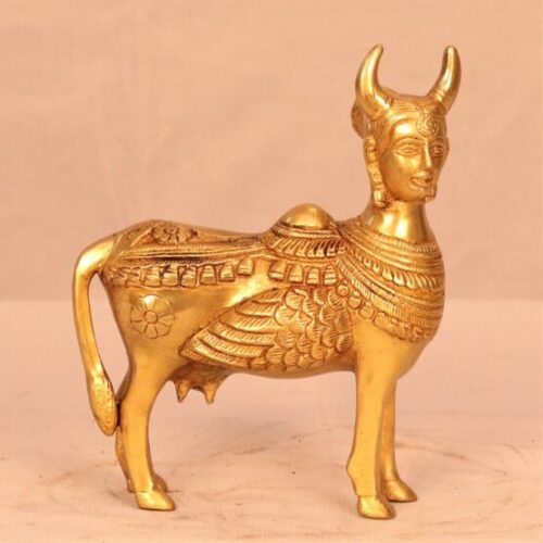 A golden brass standing Kamdhenu