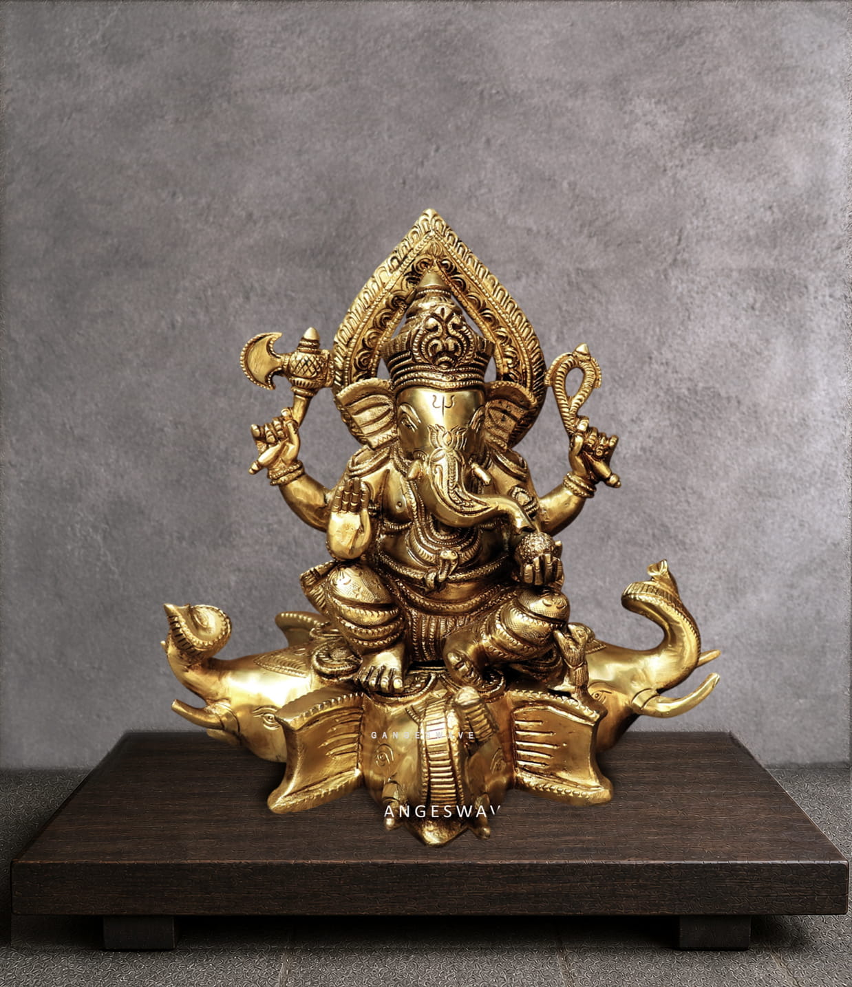 Brass ganesh statue sitting on gajapati