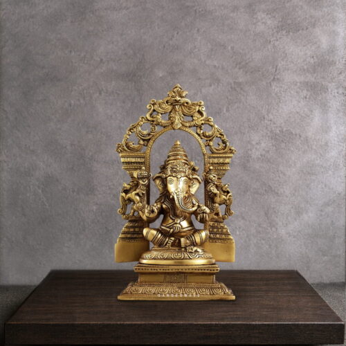 Handcrafted Brass Ganesha Statue with ornate Prabhavali arch, premium solid brass idol for home temple, office décor, pooja room, meditation space, and luxury interiors.