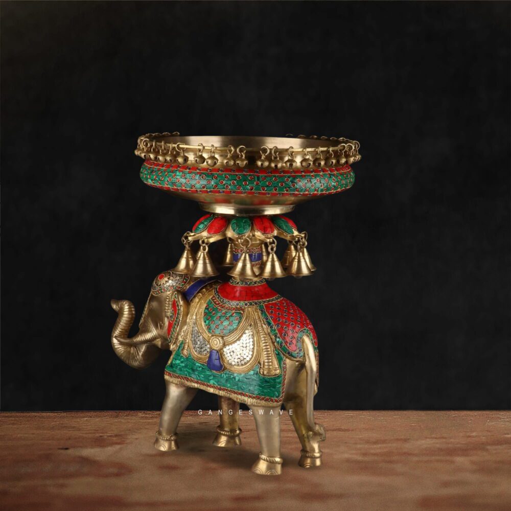Decorative brass elephant urli bowl with hand-painted red and green enamel detailing