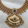 Temple style gold necklace set worn with saree for wedding look