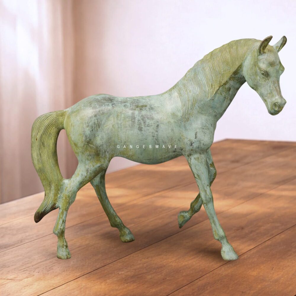 Luxury handcrafted brass horse statue with antique green patina finish placed on wooden surface