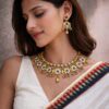 Antique gold floral temple necklace with pastel stones kundan and pearl detailing for bridal wear