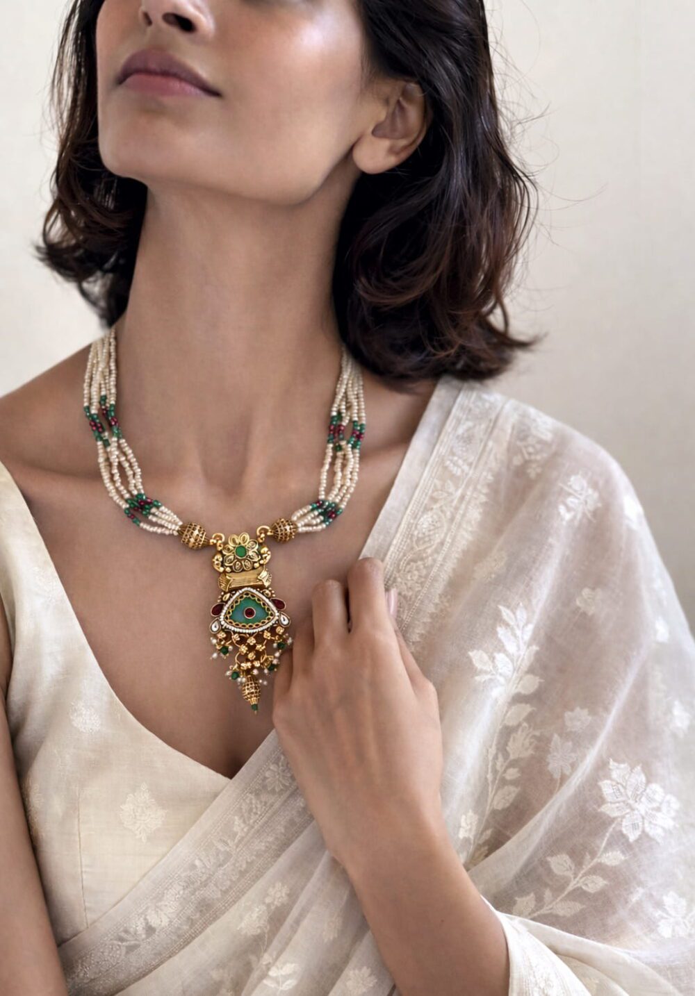 Handcrafted pearl Kundan pendant necklace with gold finish and green ruby stone detailing