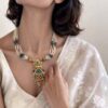 Handcrafted pearl Kundan pendant necklace with gold finish and green ruby stone detailing