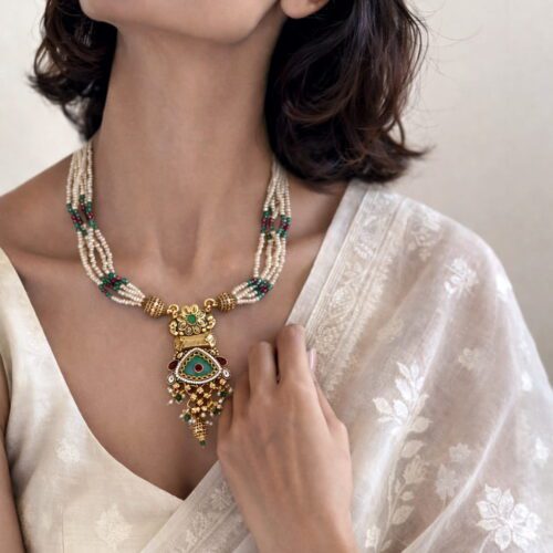 Handcrafted pearl Kundan pendant necklace with gold finish and green ruby stone detailing