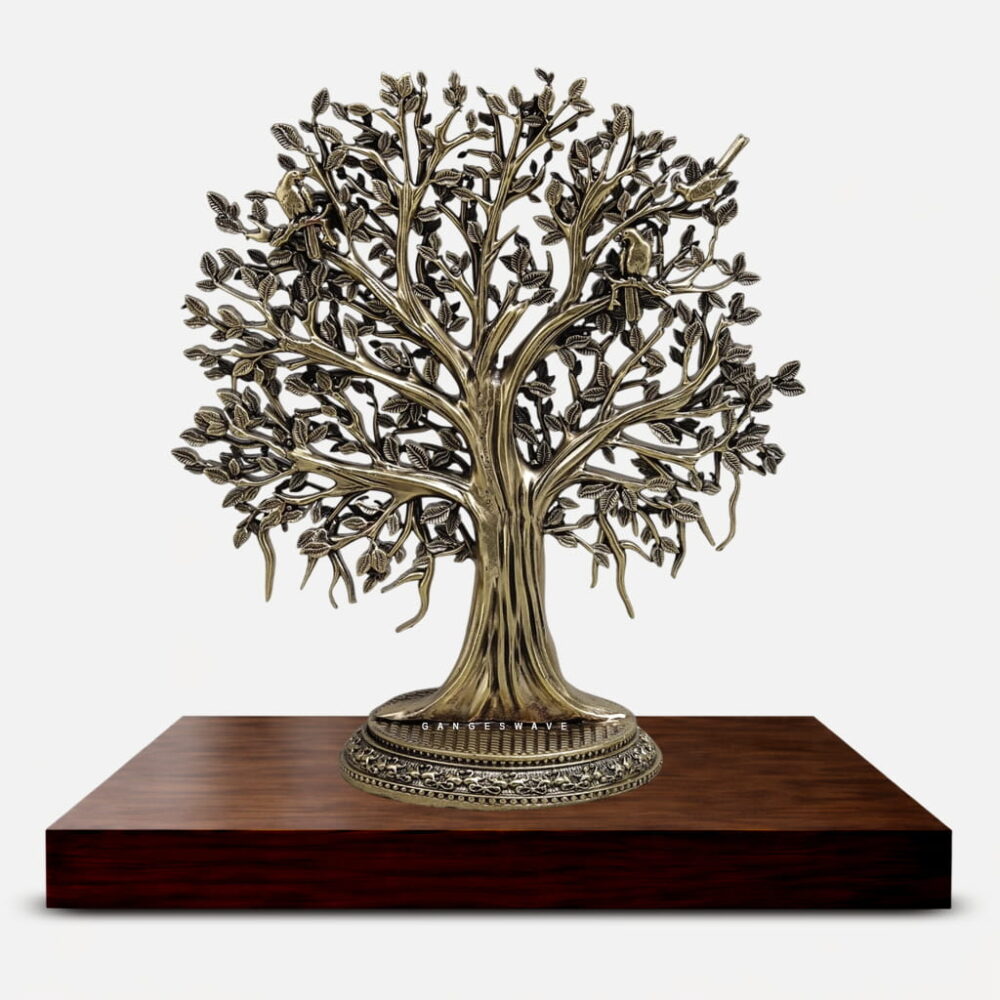 Handcrafted brass Kalpavriksha tree sculpture with detailed branches, birds, and antique finish placed on a wooden base for luxury home decor