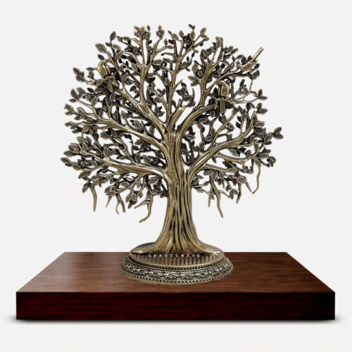 Handcrafted brass Kalpavriksha tree sculpture with detailed branches, birds, and antique finish placed on a wooden base for luxury home decor