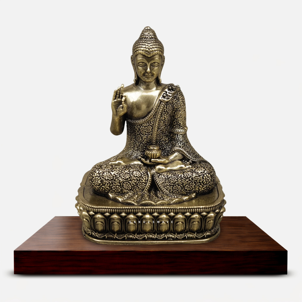 Handcrafted antique brass meditating Buddha statue with intricate floral engraving seated on an ornamental lotus pedestal for home décor and meditation.
