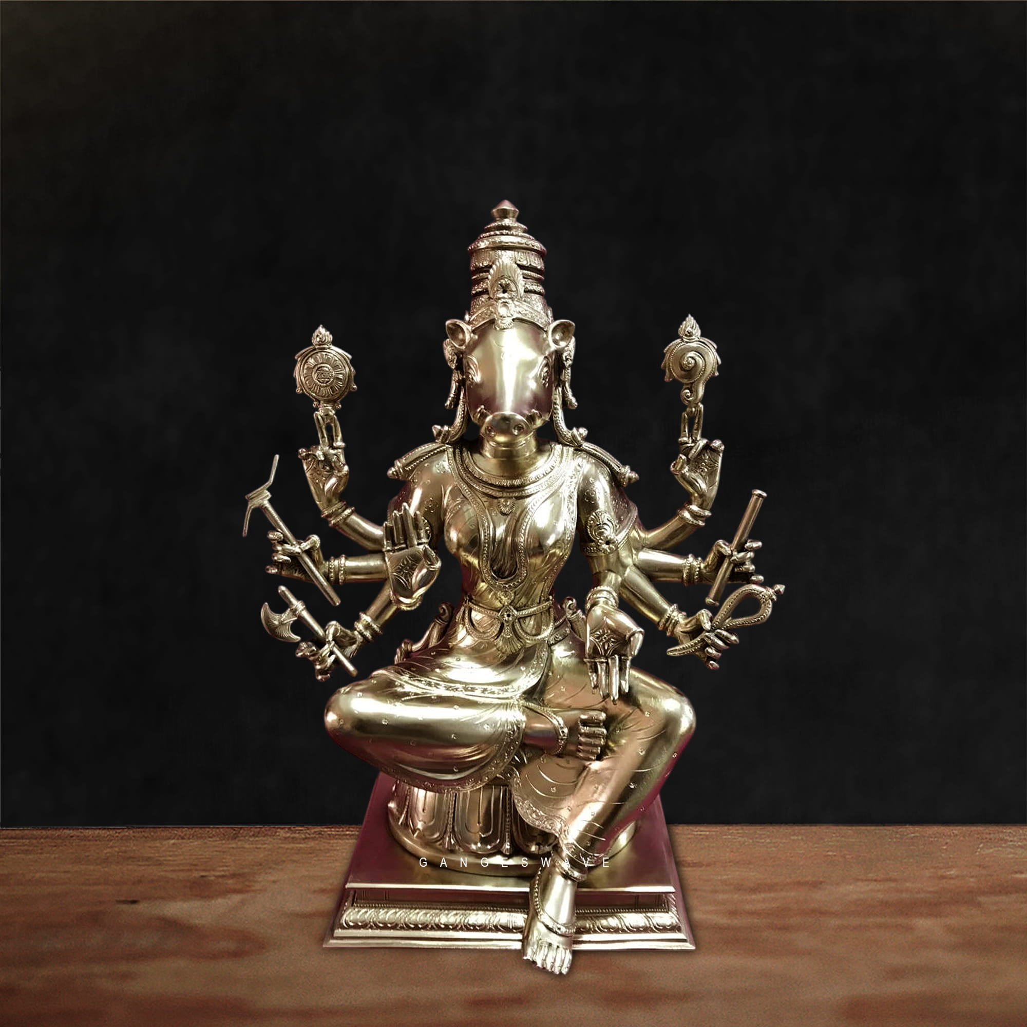 Handcrafted superfine brass Varahi Devi statue seated in meditative posture with multiple arms holding symbolic weapons, detailed antique finish Hindu goddess idol for home temple decor.