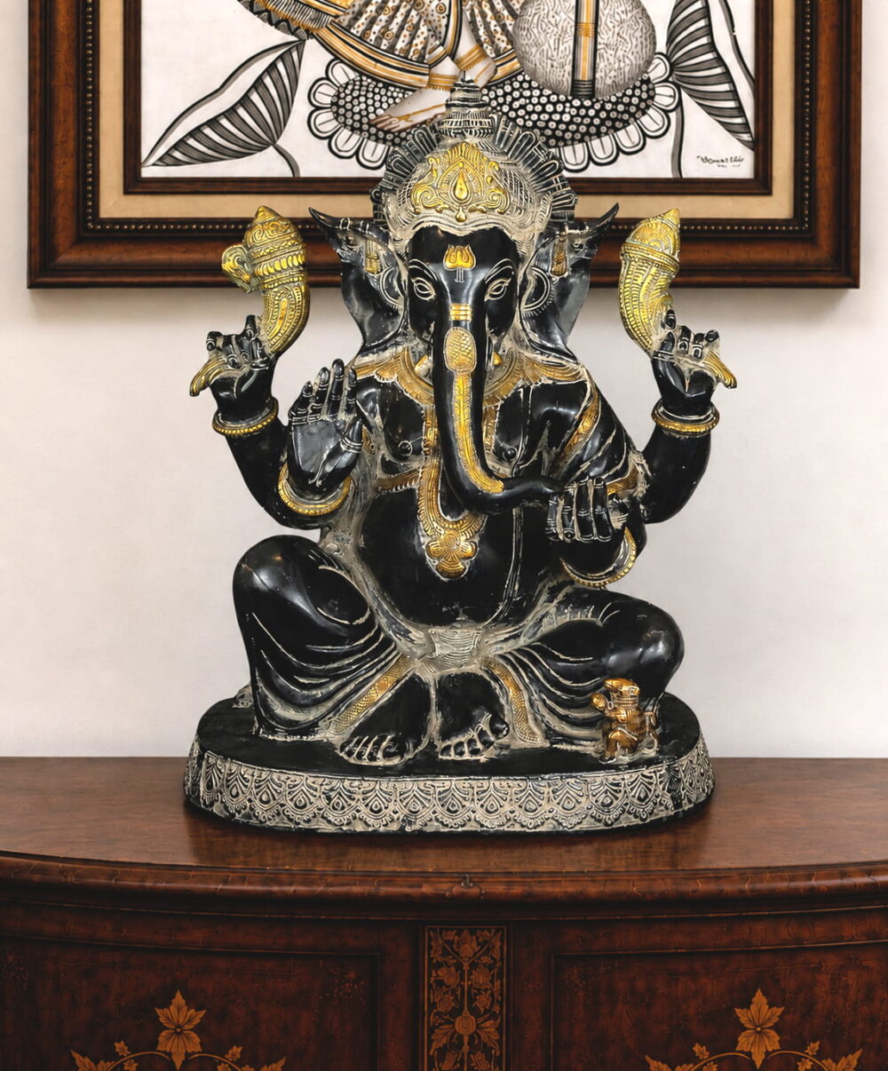Handcrafted black brass Lord Ganesha idol with silver and gold detailing for luxury home temple décor.