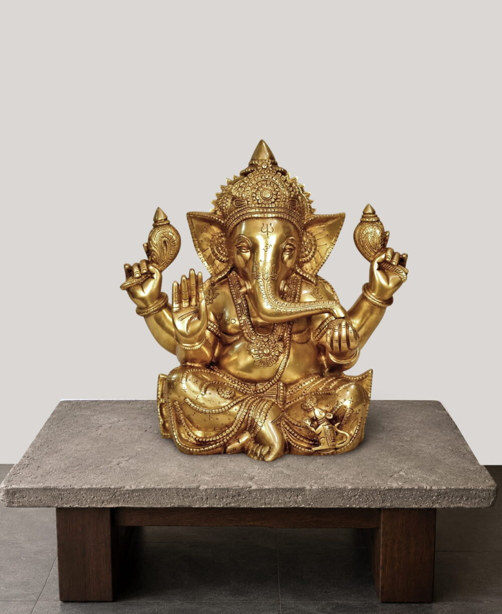 Handcrafted Brass Sitting Ganesha Statue with ornate crown and Abhaya Mudra, crafted from premium solid brass for home temple, office décor, pooja room, and luxury interiors.