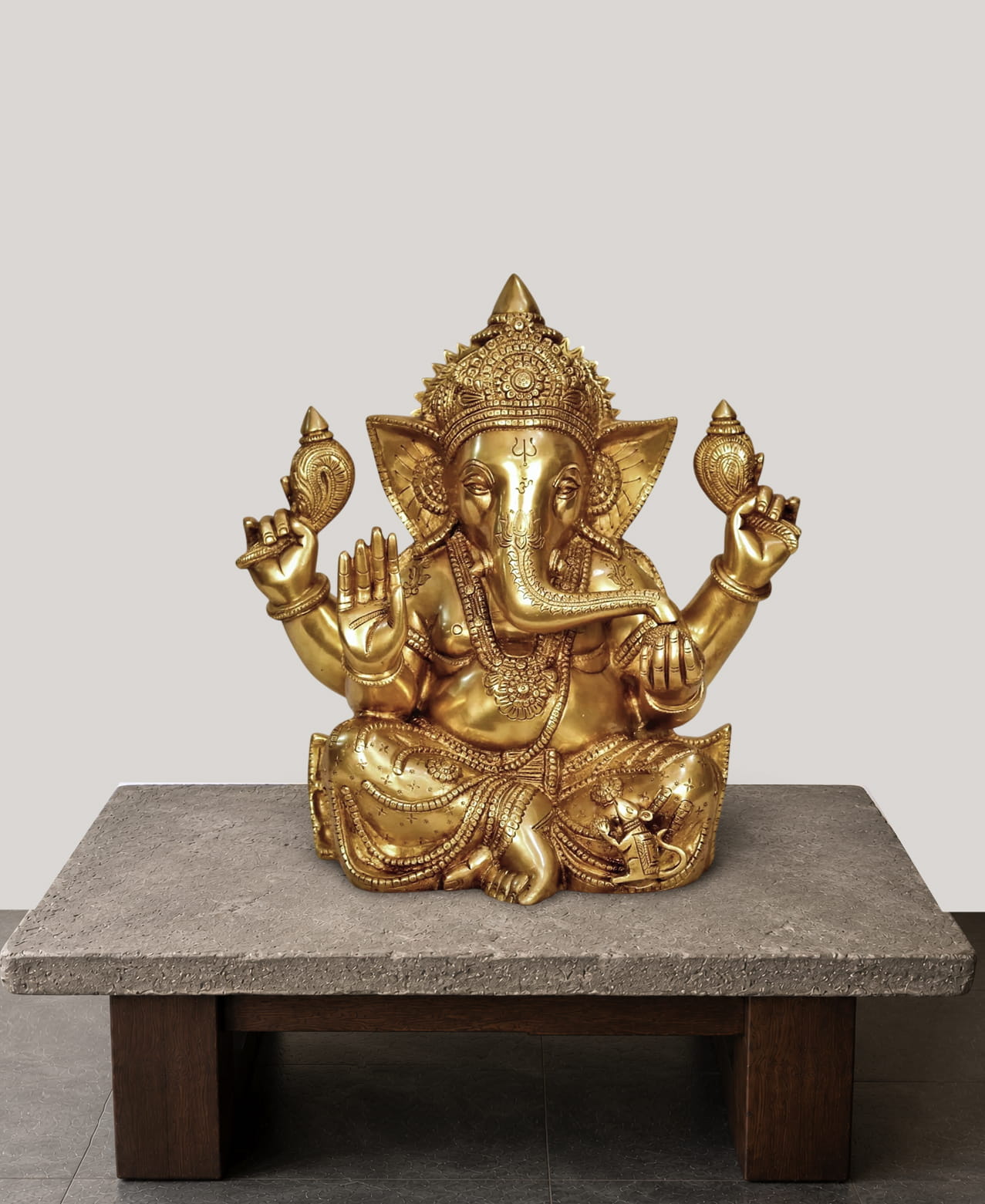 Handcrafted Brass Sitting Ganesha Statue with ornate crown and Abhaya Mudra, crafted from premium solid brass for home temple, office décor, pooja room, and luxury interiors.