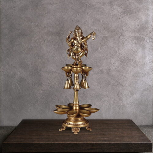 Antique brass dancing Ganesha diya with hanging bells and multi-tier oil lamp bowls, handcrafted Nritya Ganapati statue for Hindu puja and aarti