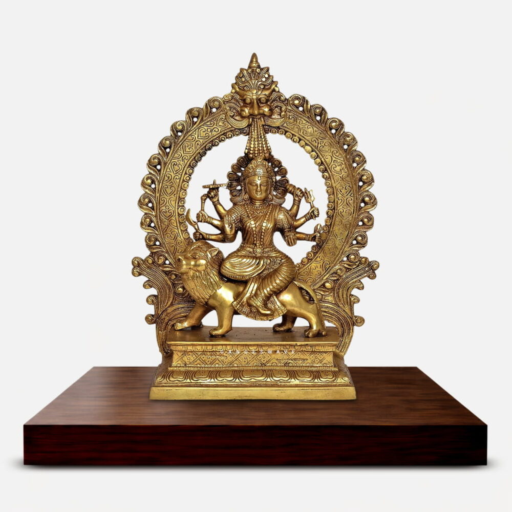Handcrafted brass Durga idol depicting eight-armed Goddess Durga seated on a lion with antique golden finish, ornate prabhavali arch, and intricate filigree details. Perfect for pooja room and spiritual home decor.