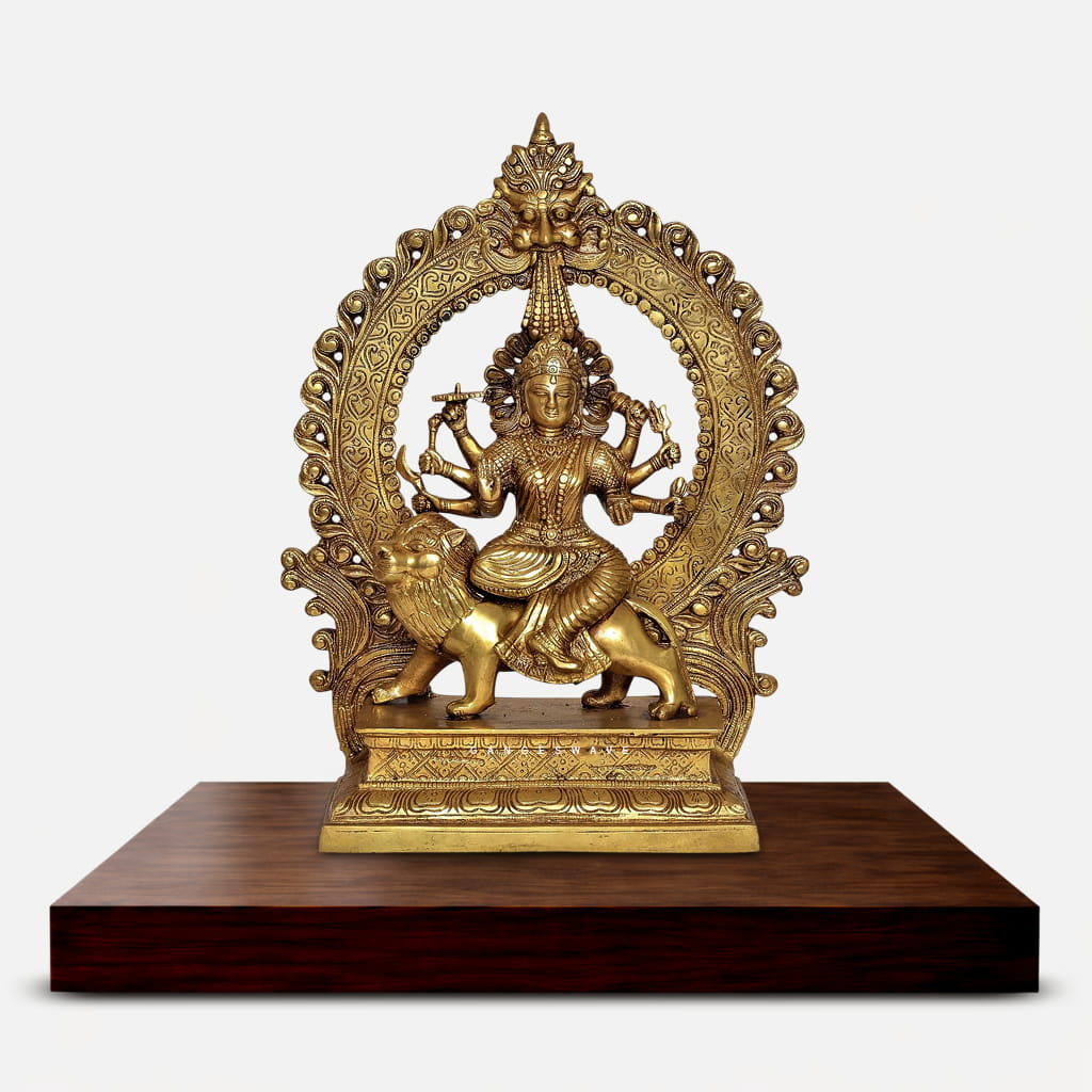 Handcrafted brass Durga idol depicting eight-armed Goddess Durga seated on a lion with antique golden finish, ornate prabhavali arch, and intricate filigree details. Perfect for pooja room and spiritual home decor.