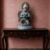 Handcrafted vintage brass Garuda statue with antique blue-grey finish, detailed wings, folded hands and golden accents for luxury spiritual home decor.