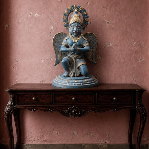 Handcrafted vintage brass Garuda statue with antique blue-grey finish, detailed wings, folded hands and golden accents for luxury spiritual home decor.