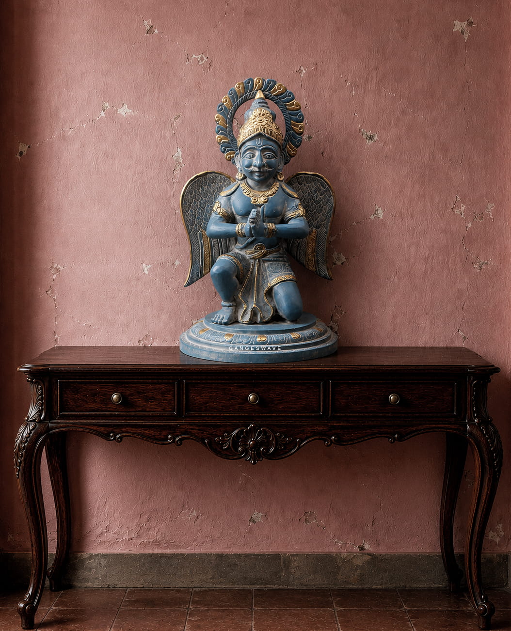 Handcrafted vintage brass Garuda statue with antique blue-grey finish, detailed wings, folded hands and golden accents for luxury spiritual home decor.