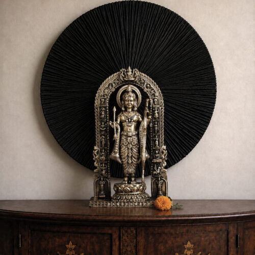 Brass Ram Lalla idol standing with bow and arrow beneath an ornate traditional arch
