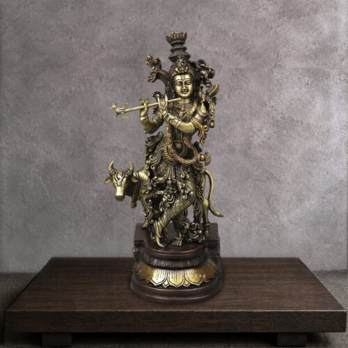 Krishna with cow brass statue depicting Lord Krishna playing the flute beside a sacred cow