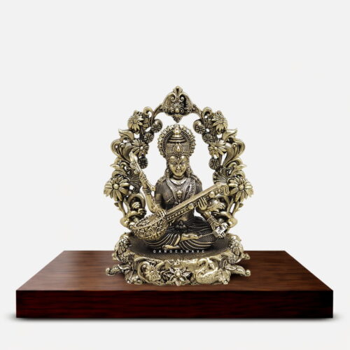 Small handcrafted Brass Saraswati Idol with Veena and ornate floral frame