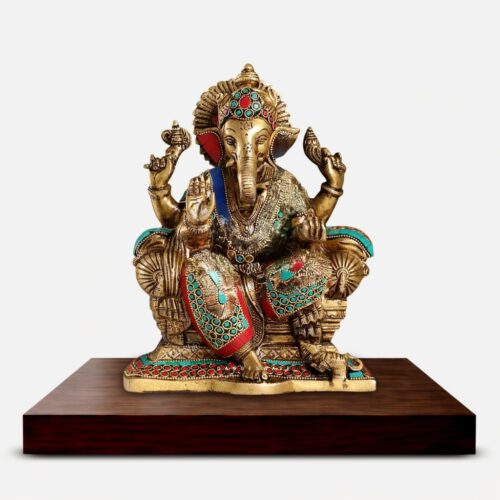 Handcrafted Meenakari Brass Ganesha idol seated on an ornate takiya throne with turquoise and red decorative detailing