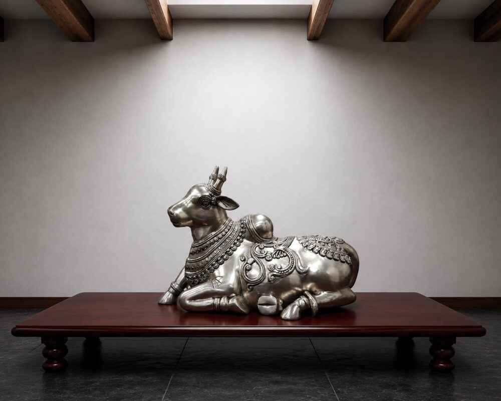 Handcrafted silver finish brass Nandi statue with intricate traditional carvings for Shiva temple, luxury home décor and spiritual interiors.