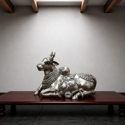 Handcrafted silver finish brass Nandi statue with intricate traditional carvings for Shiva temple, luxury home décor and spiritual interiors.