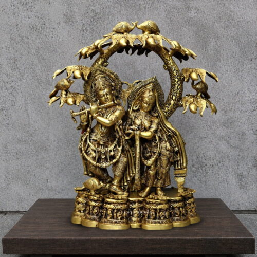 Radha Krishna brass statue under a Kadamba tree with Krishna playing flute