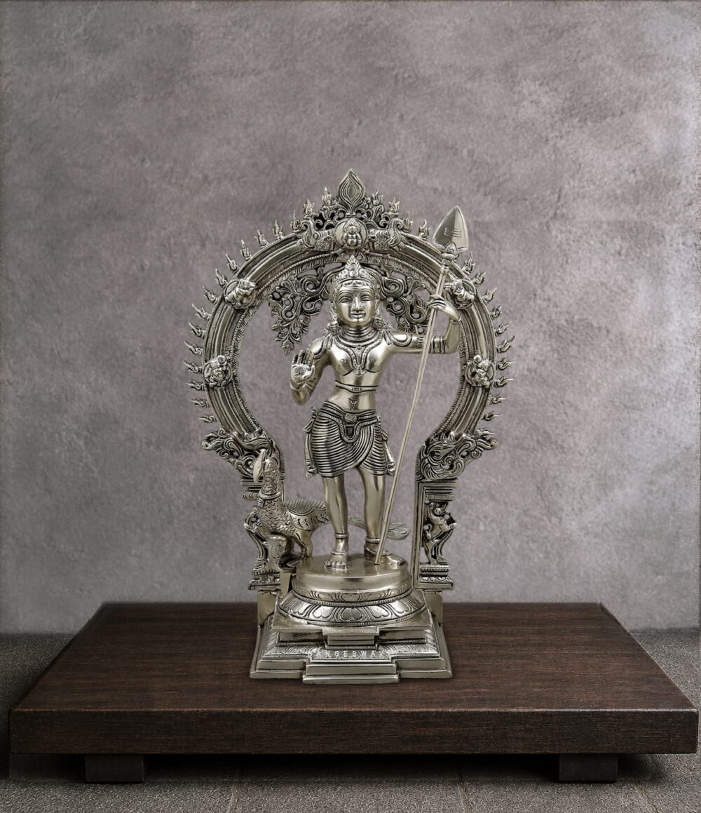 Handmade premium solid brass Lord Murugan statue with sacred Vel, ornate Prabhavali arch and peacock for home temple, spiritual décor and luxury interiors.