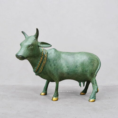 Vintage brass cow statue with antique green patina and gold accents