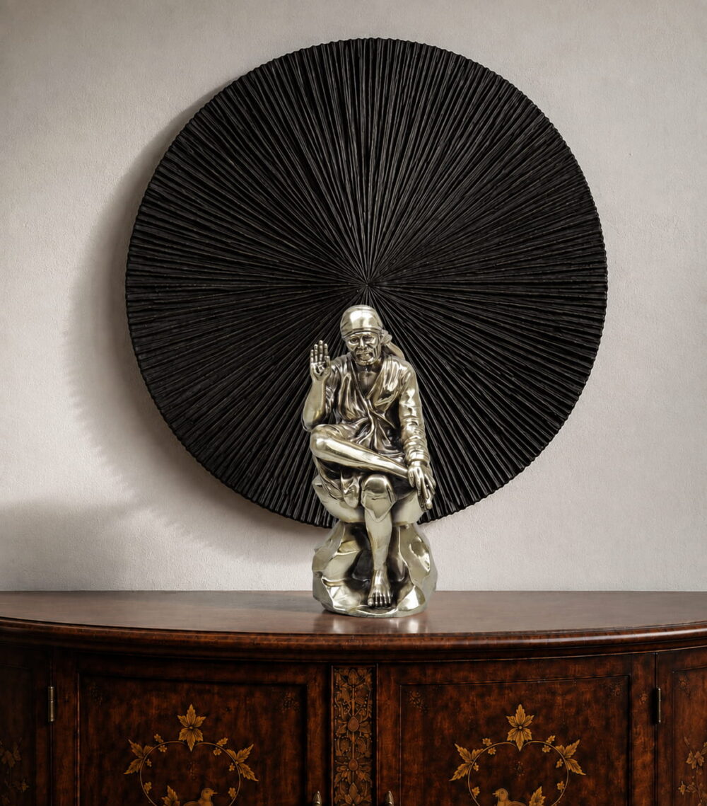 Seated Sai Baba idol in blessing pose with circular radial halo