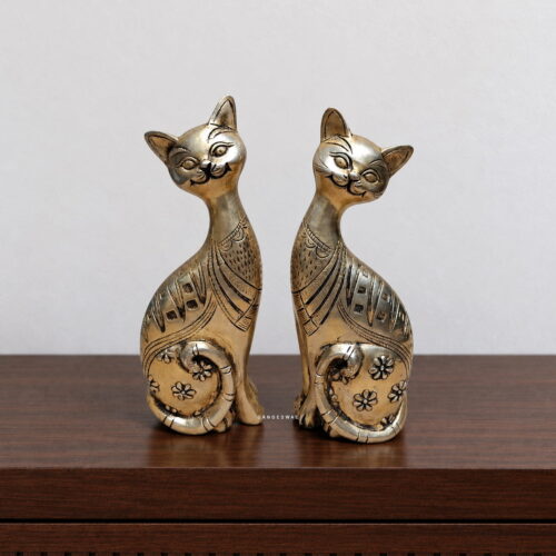 Intricately detailed brass cat figurines designed as an elegant decorative pair.
