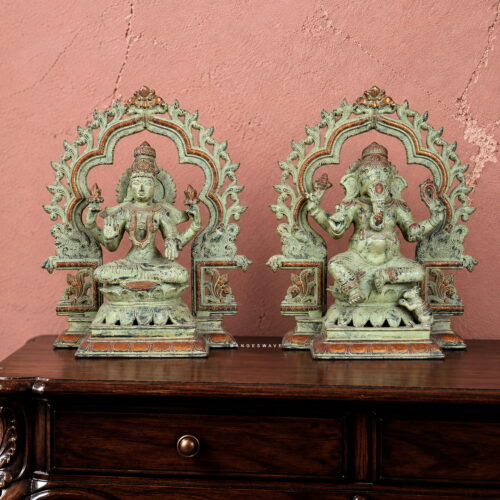Antique green patina brass Lakshmi Ganesha statue pair with ornate traditional arches